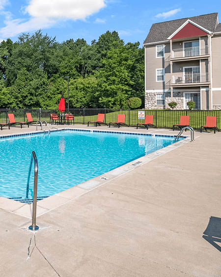 a swimming pool with a building in the background