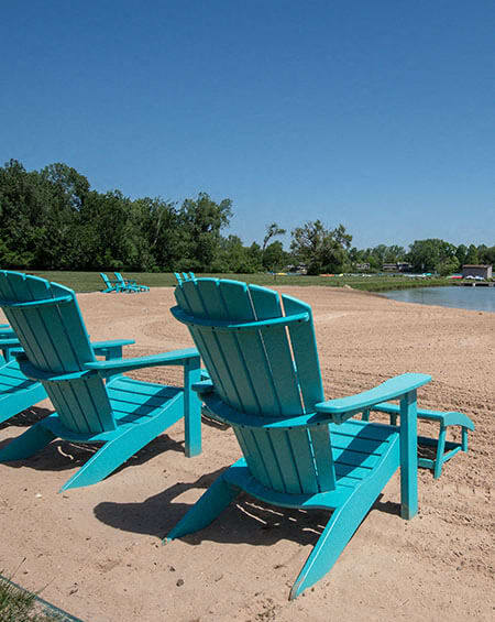 two blue beach chairs sitting on the beach