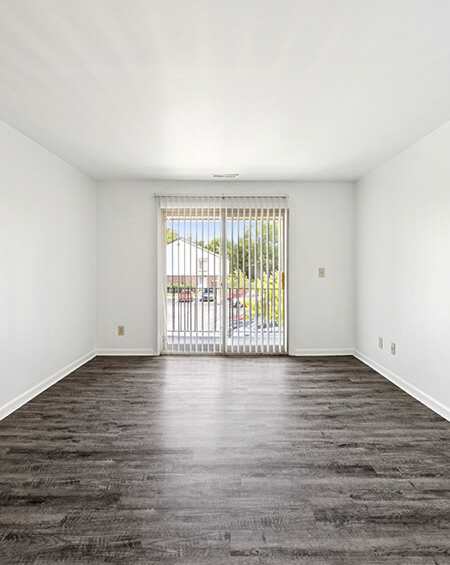 A room with a grey carpet and white walls.