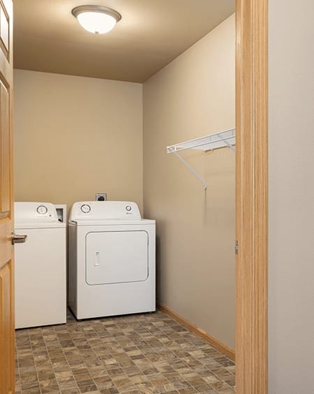 A small laundry room with a washer and dryer.