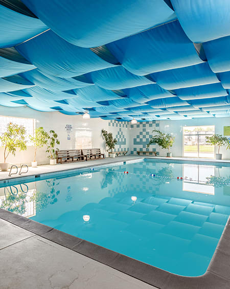 a swimming pool with a blue ceiling above it
