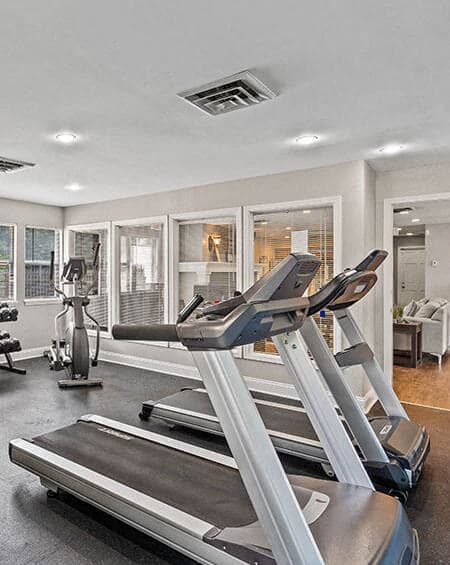 a gym with a treadmill and other equipment