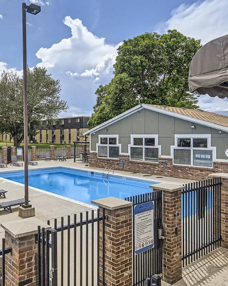 a swimming pool with a building in the background