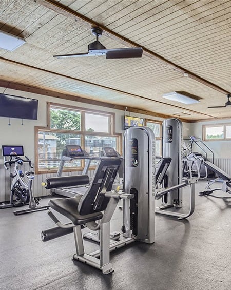a gym with cardio machines and other exercise equipment