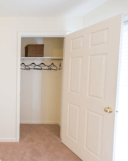 an empty closet with a white door