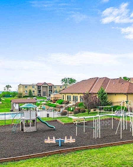 a park with a playground and a building