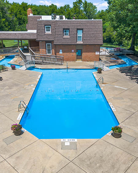 a large swimming pool with a building in the background