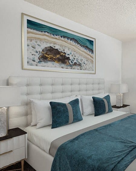 a bedroom with a bed and a painting on the wall