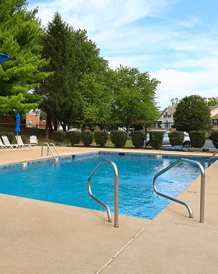 a swimming pool with a metal fence around it