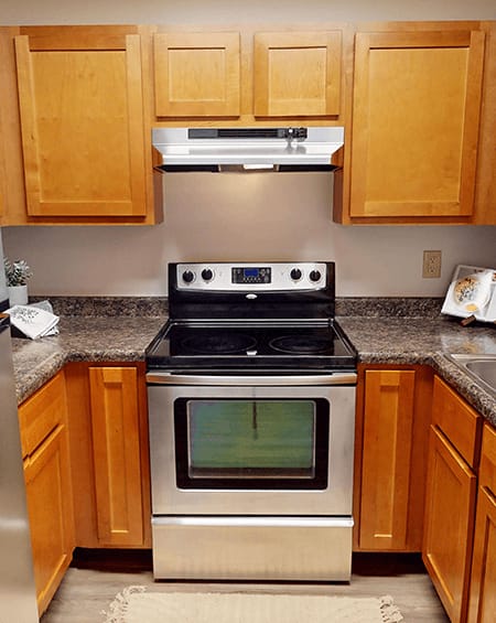 A kitchen with a stove and oven built into the counter.