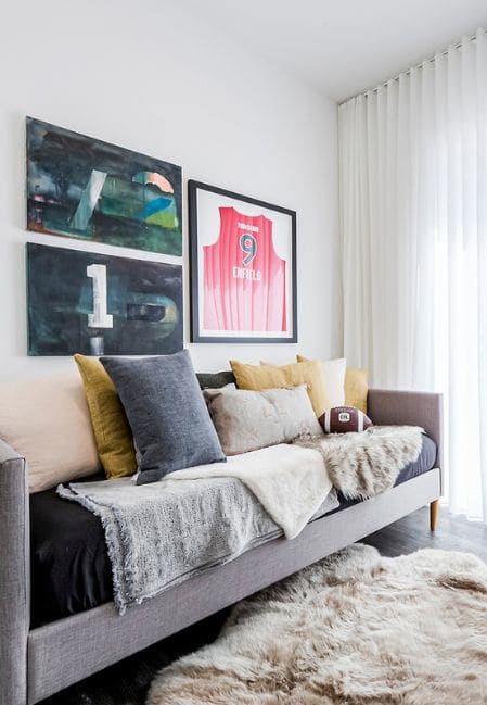 a living room with a couch and pictures on the wall