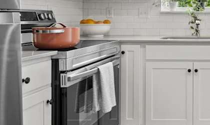A modern kitchen with a stainless steel refrigerator, oven, and microwave.