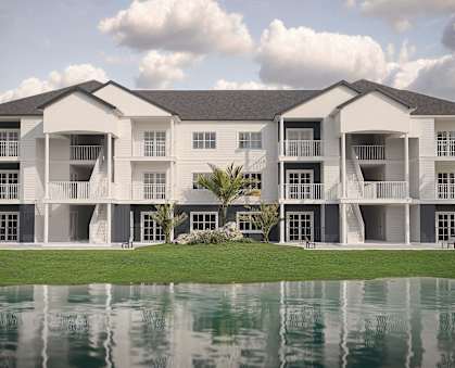 an image of an apartment building next to a body of water