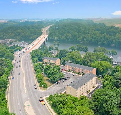 an aerial view of a highway and a bridge over a river