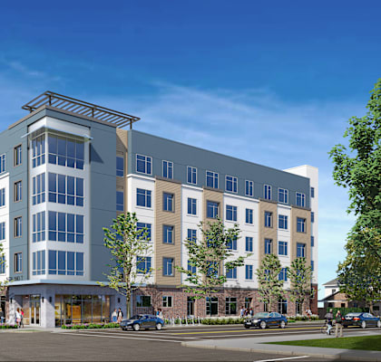 A modern multi-story building with a mix of beige and blue panels.