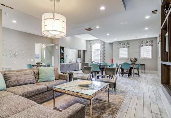 a living room with couches and chairs and a table