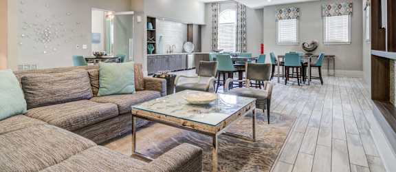 a living room with couches and chairs and a table