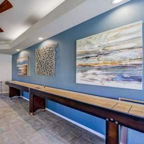 A room with a blue wall and a wooden bench.