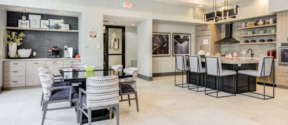 A modern kitchen with a dining table and chairs.
