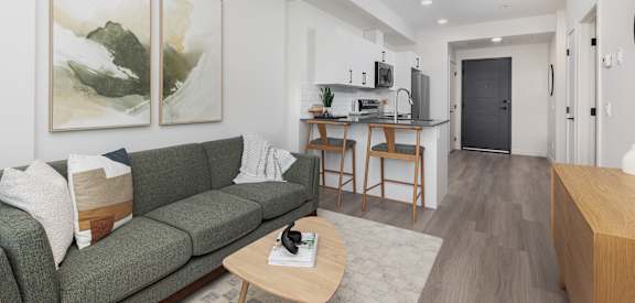 A living room with a green couch and a coffee table.