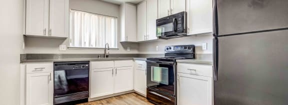 a kitchen with stainless steel appliances and white cabinets