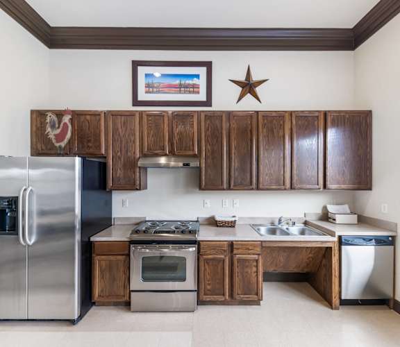 a kitchen with stainless steel appliances and wooden cabinets