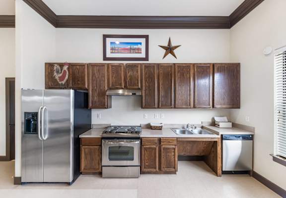 a kitchen with stainless steel appliances and wooden cabinets