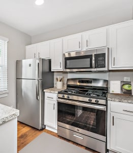 an updated kitchen with stainless steel appliances and granite counter tops