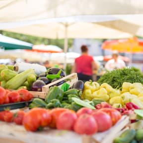 a farmer's market with a variety of vegetables on a table