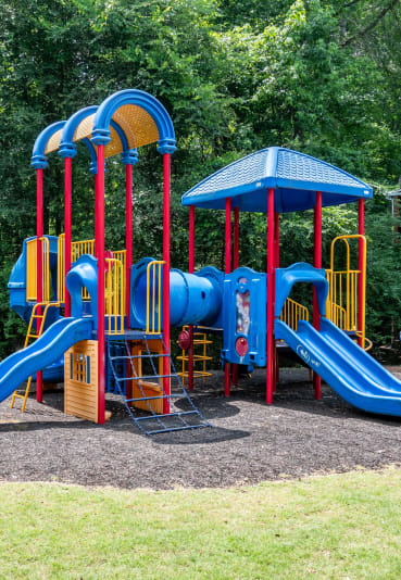 a colorful playground with slides and a picnic table