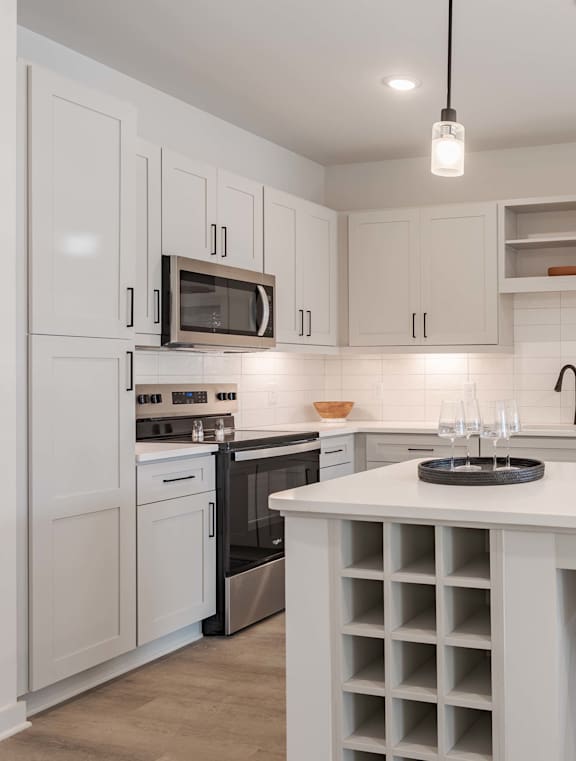 a kitchen with a large island and a white counter top