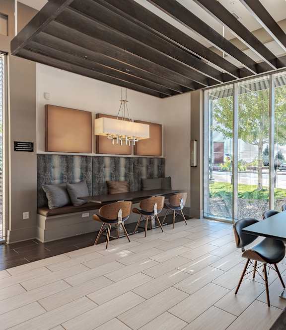 A modern dining room with a black table and chairs.