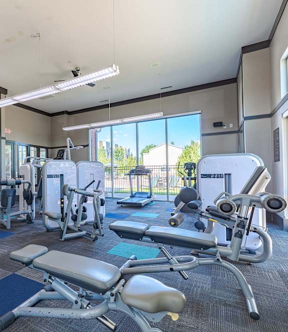A gym with a variety of equipment including a leg press machine.