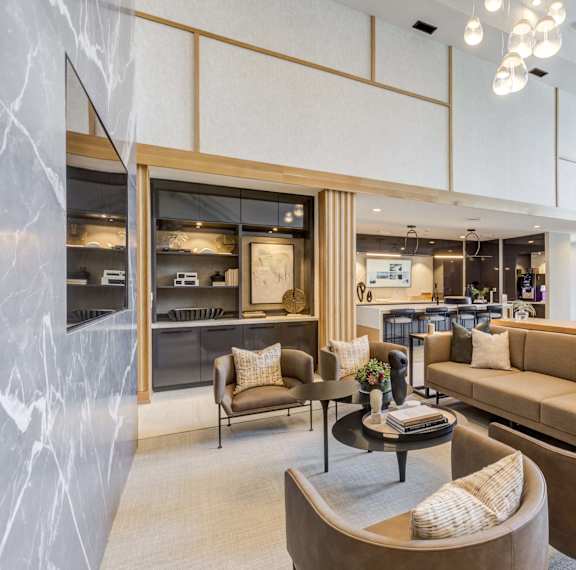 a living room with couches and chairs and a kitchen