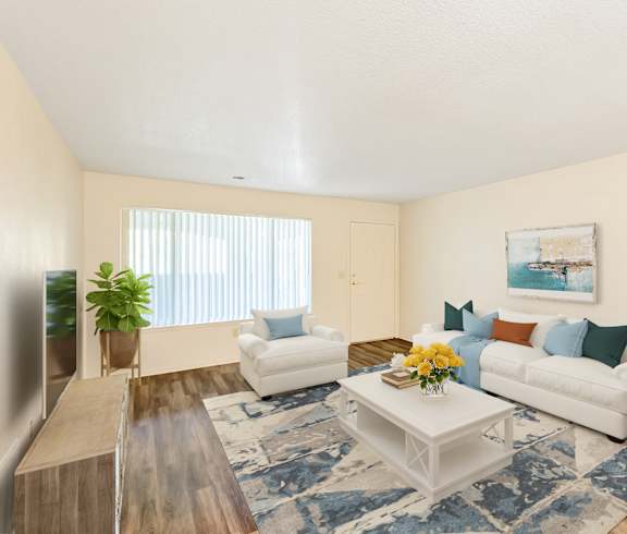 A living room with a white couch, a coffee table, and a painting on the wall.