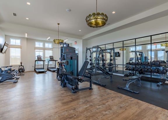 Fitness center at Outpost Orchard in Foley, AL, equipped with modern exercise machines and free weights.