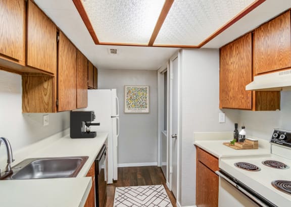 a kitchen with a sink stove and oven