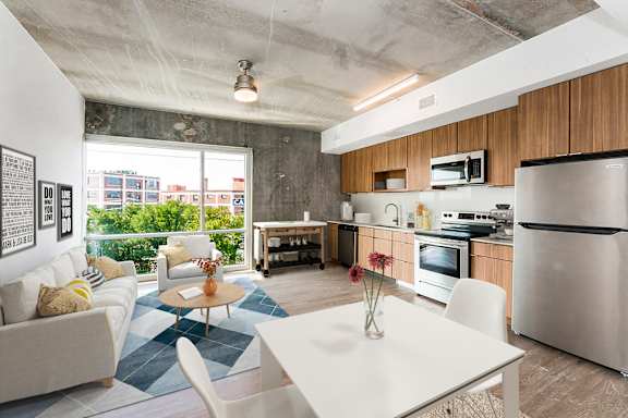 A modern kitchen with a dining table and chairs.