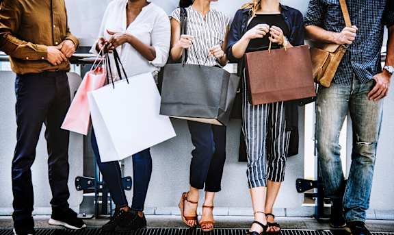 a group of people holding shopping bags