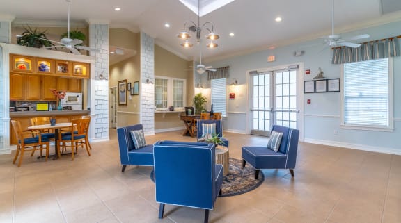 the living room and dining room of a house with blue furniture