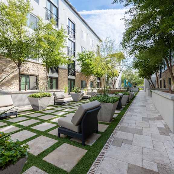 A pool area with chairs and a fountain at Cohea Archibalds.