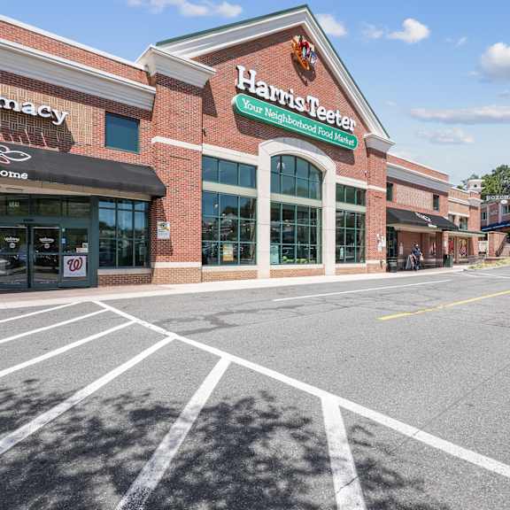 Harris Teeter is a green sign on a brick building.