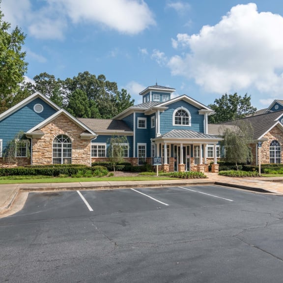 an empty parking lot in front of a house