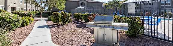 A sunny day at a residential area with a pool and a BBQ grill.
