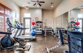 the gym with cardio equipment at the belgard apartments mn