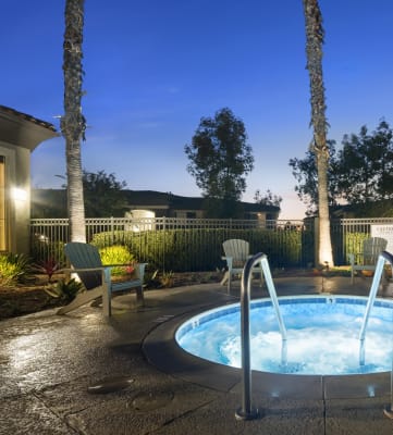 a jacuzzi in the backyard of a house at night