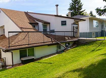 a balcony with a railing on the side of a house