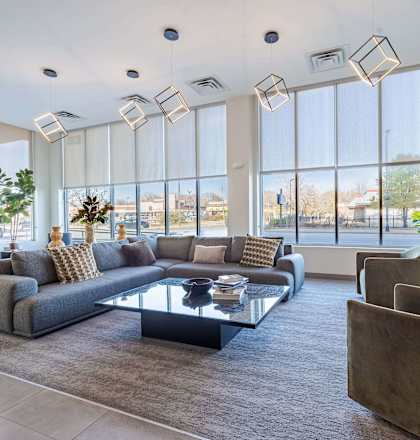 A modern living room with a large sectional sofa and a glass coffee table.