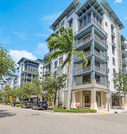 a large apartment building on the corner of a city street