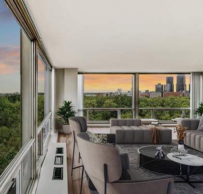 a living room filled with furniture and a large window at The Pavilion, Detroit, 48207
